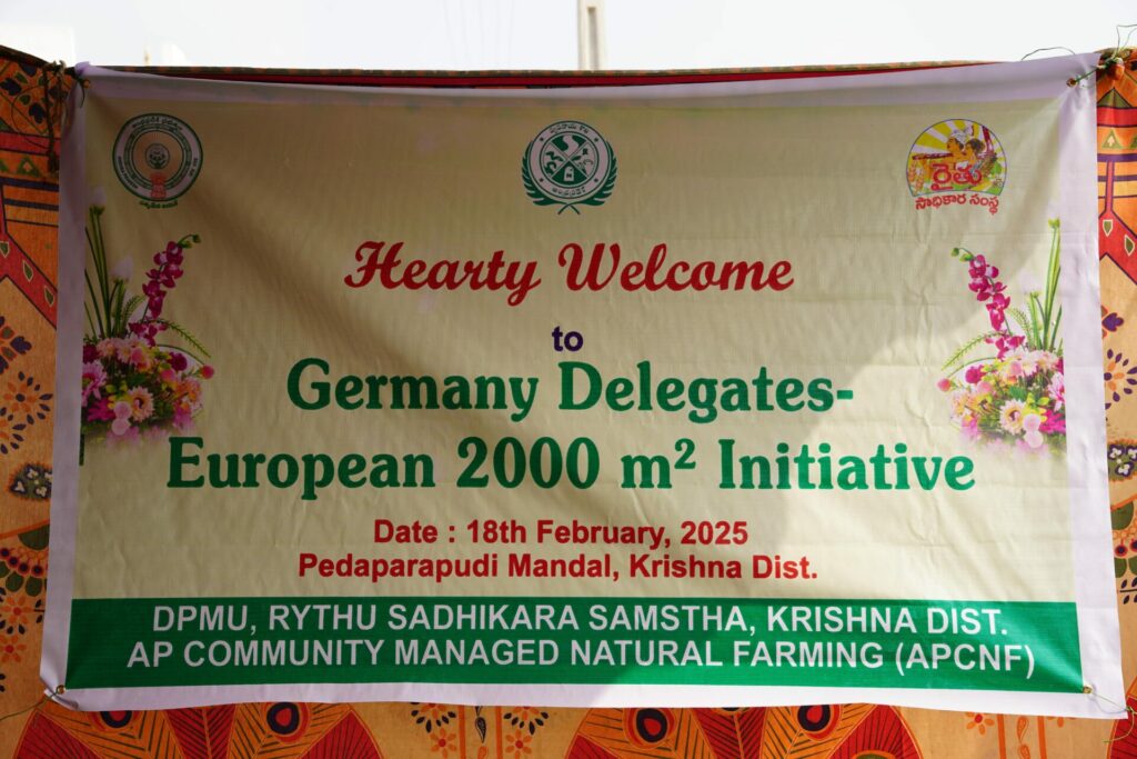 A printed banner reads “Hearty Welcome to German Delegates- European 2000 m² Initiative”.
