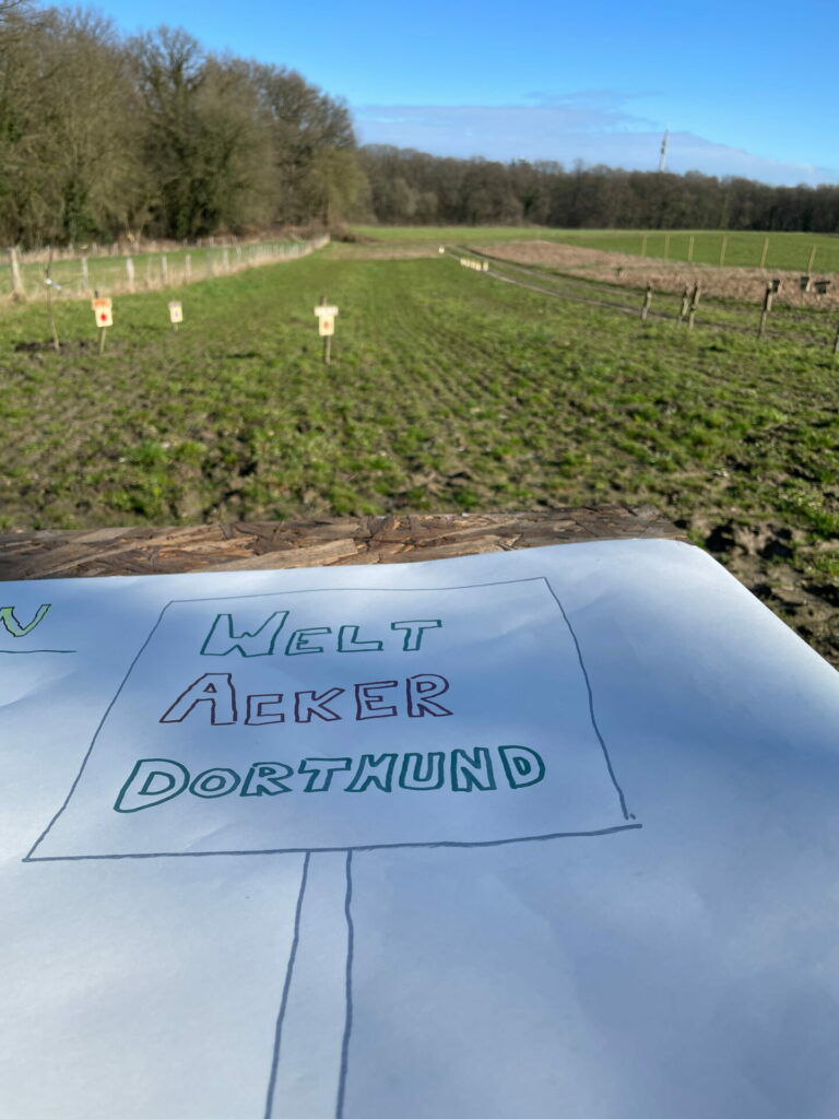 A hand-drawn note lies in front of the Global Field, with "Global Field Dortmund" written on it.  